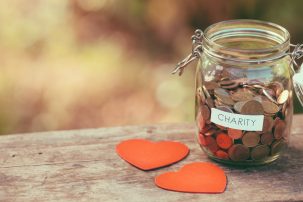 jar of coins for charity with two cut out hearts