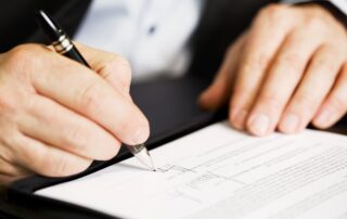 businessman signing document