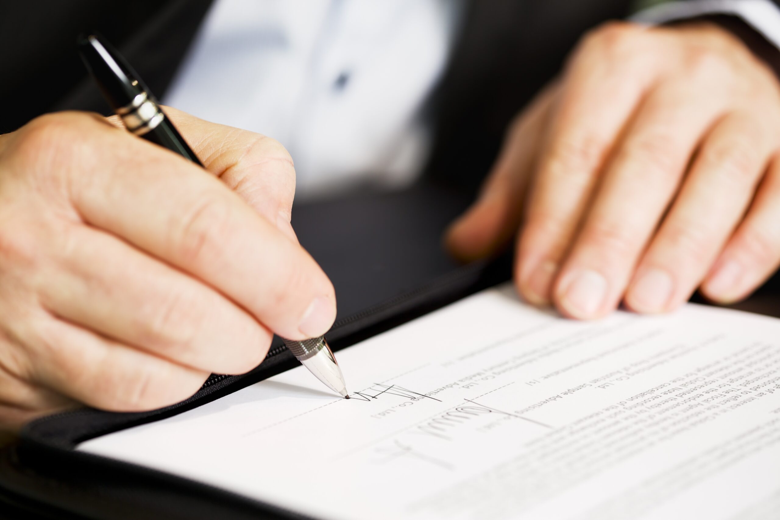 businessman signing document