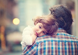 child on her dads shoulder