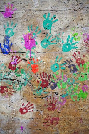 child hand prints painted on wood