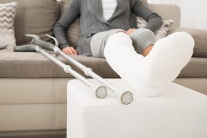 woman on sofa with a broken leg