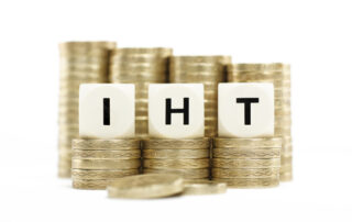 IHT letters with stack of coins