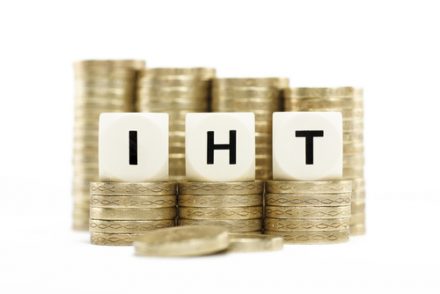 IHT letters with stack of coins