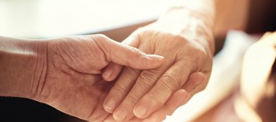 elderly hands with carer