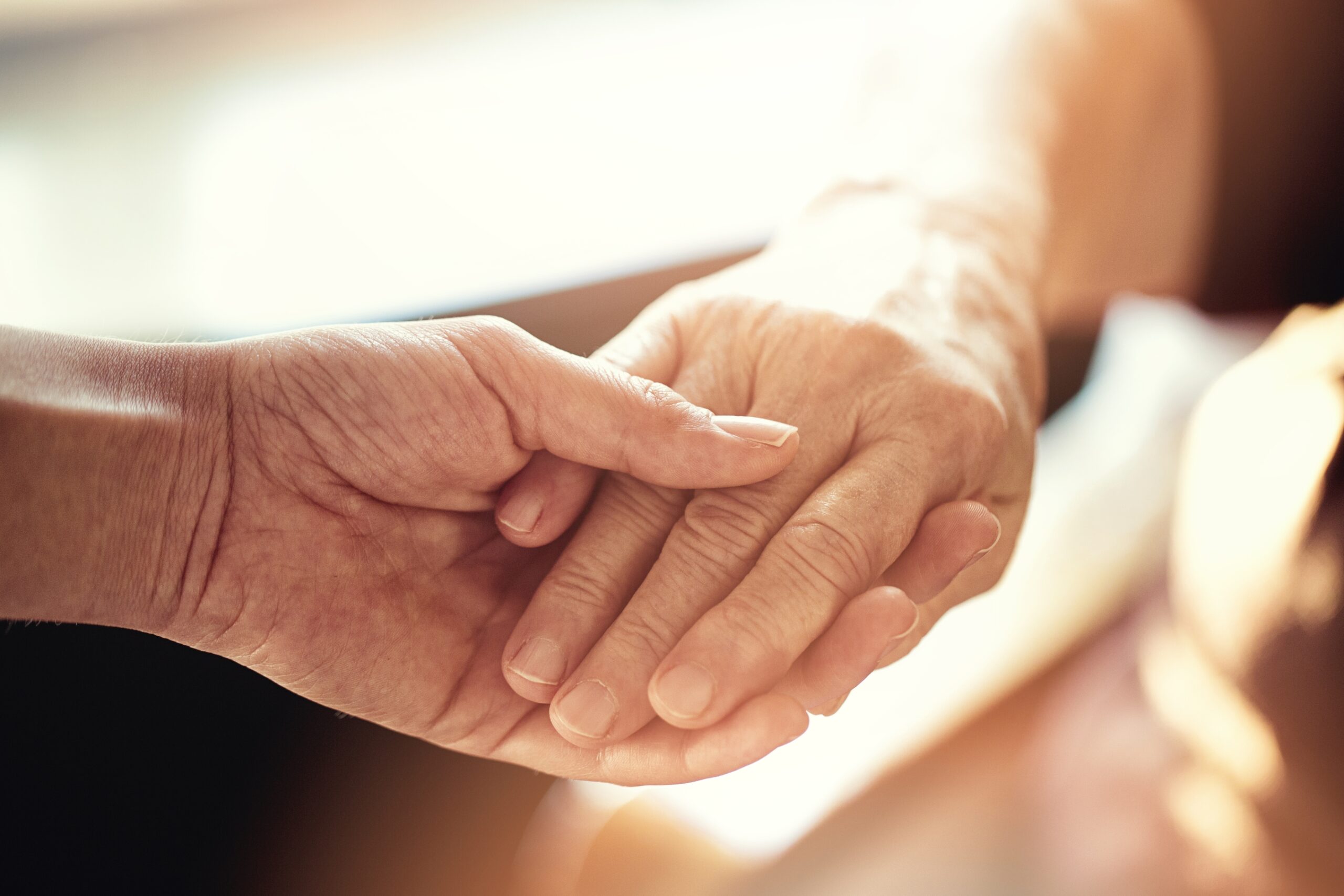 elderly hands with carer