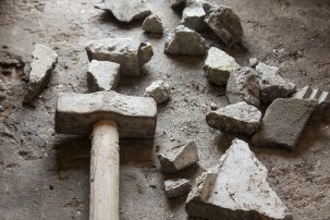 pile of rubble with hammer