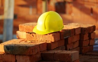 yellow protective hat sitting on a pile of bricks