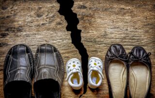 family shoes with a broken floor depicting a family split