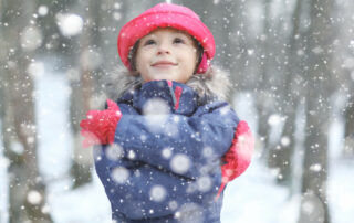 Happy girl in the snow at Christmas