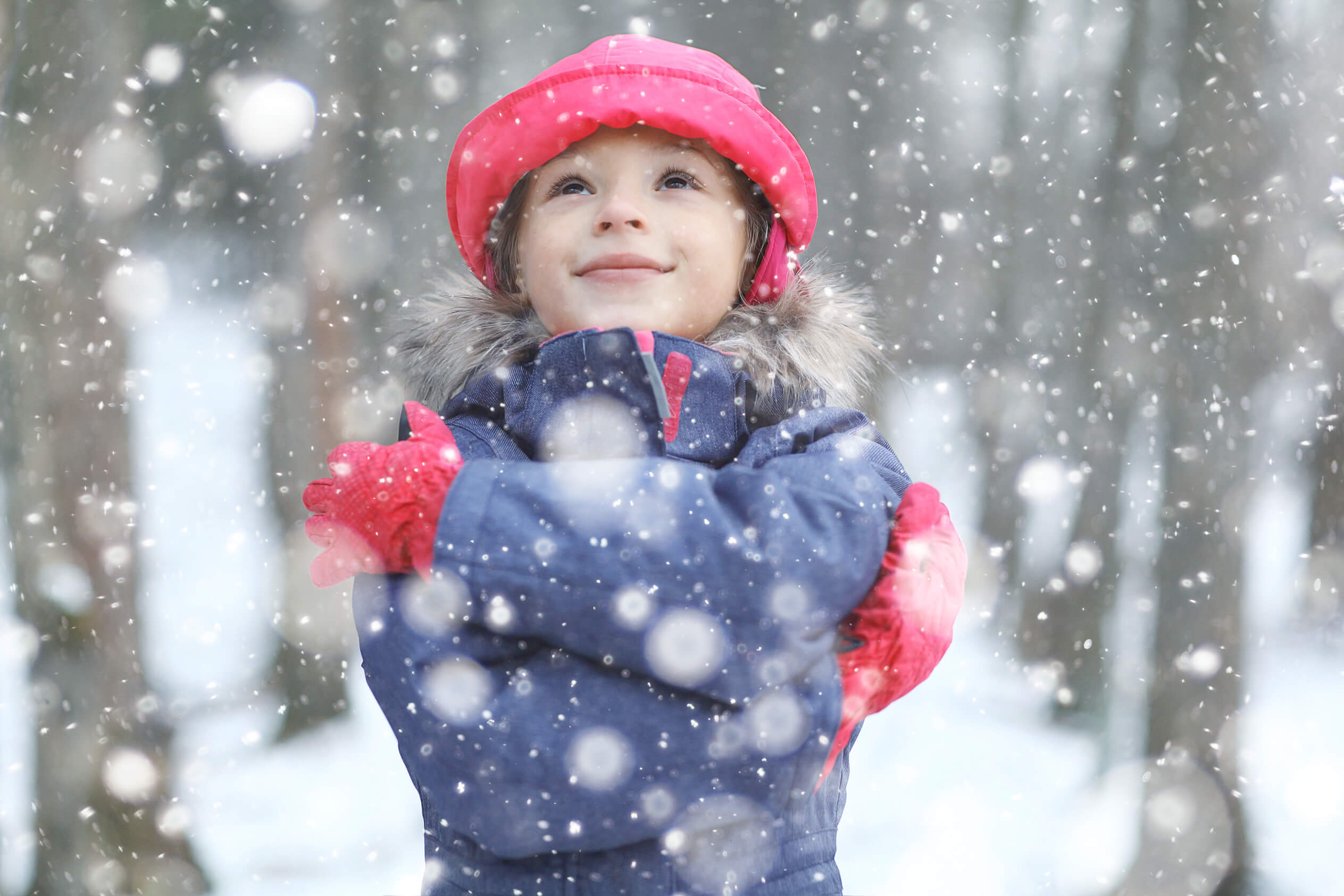 Happy girl in the snow at Christmas