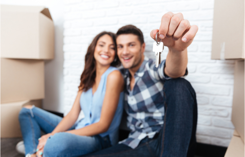 Young couple new homeowners with keys