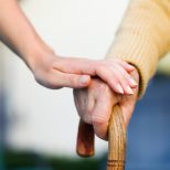 nurse holding elderly hand