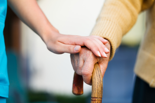 nurse holding elderly hand