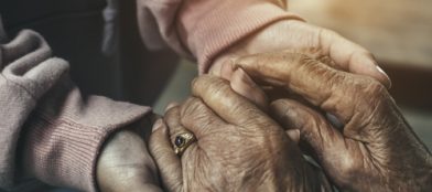 old and young hands holding