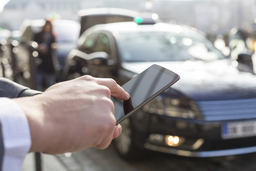 man ordering a cab using his smartphone