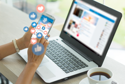 young woman using icons on her smartphone